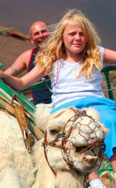 Family riding the camels at Timanfaya National Park